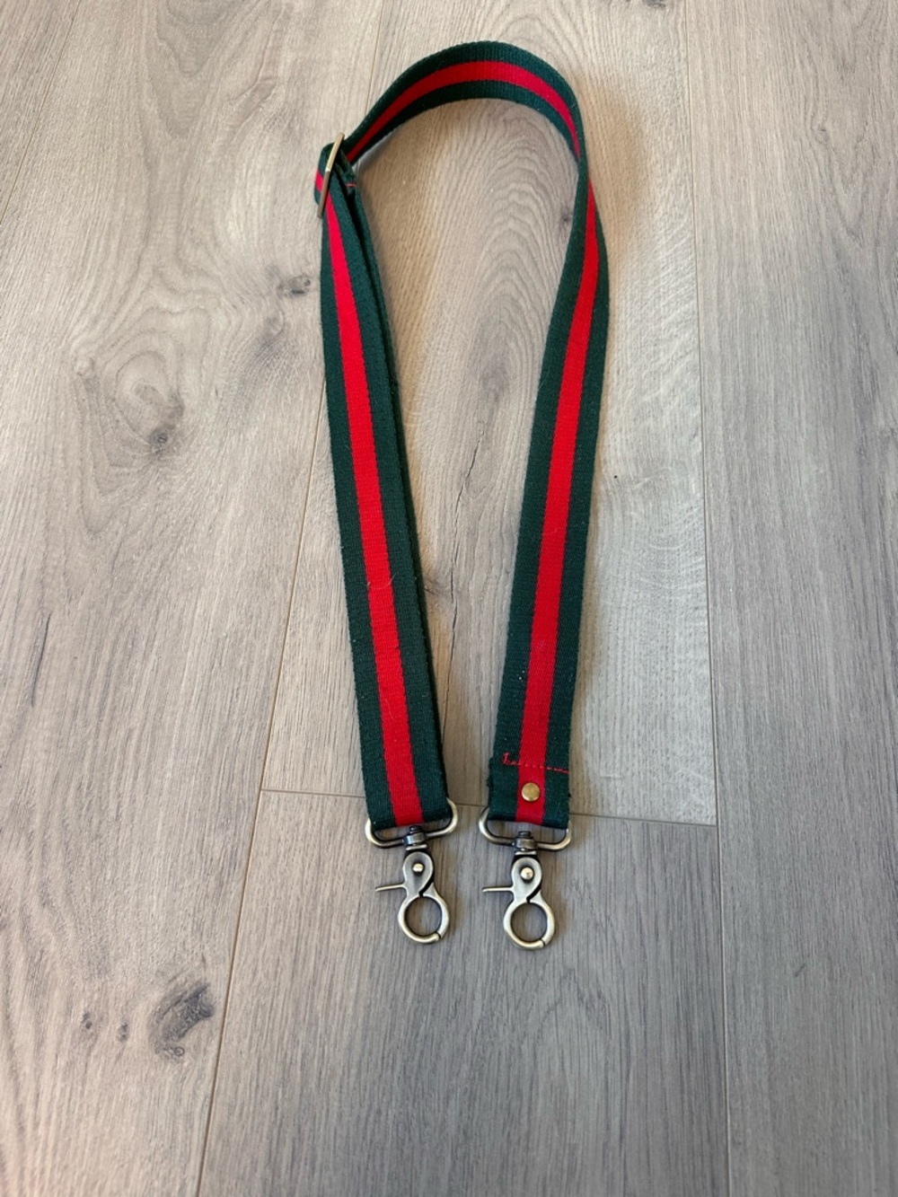 Green Webbing Crossover Strap with Central Red Stripe
